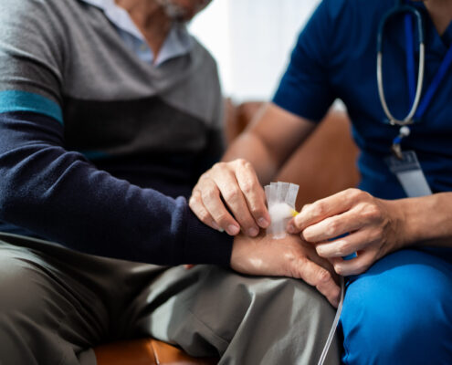 Hand Of Physiotherapist Change Wound Dressing Or Bandage For Senior Man To Take Care Wound. Home Caregiver Nurse Visit Retire Couple For Health Check Up Recovery Process Medical Service